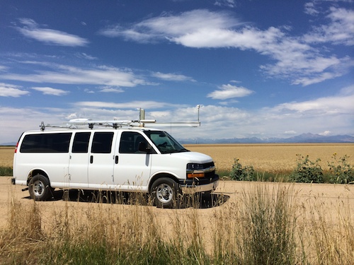 van parked on dirt road