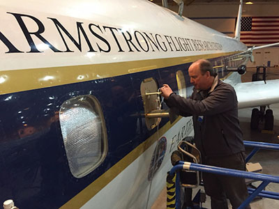 Tom Ryerson adjusting inlet installed on NASA DC-8