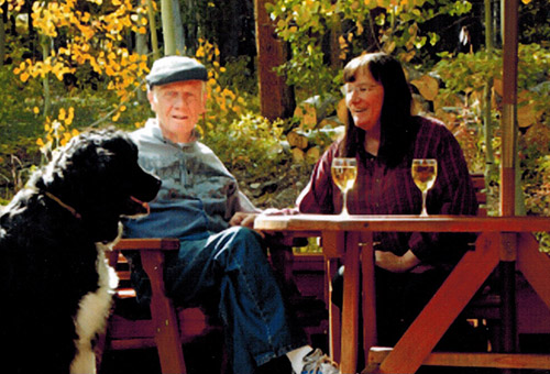 sitting at a picnic table enjoying glasses of white wine