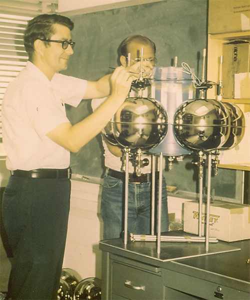 Dan Albritton works with Mack McFarland on a ballloon instrument package in the lab