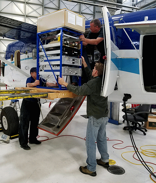 Bill Dube and Steve Brown help load NOxCaRD instrument into NOAA Twin Otter during integration